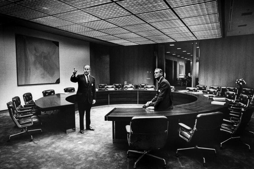 May 22, 1973--(L-R) Dr. Franklin D. Murphy chairman of Times Mirror, shows Dr. Peter S. Bing, a new director, the boardroom in the new corporate headquarters building. At left is a piece by Helen Frankenthaler. This photo appeared in the May 23, 1973, Los Angeles Times.