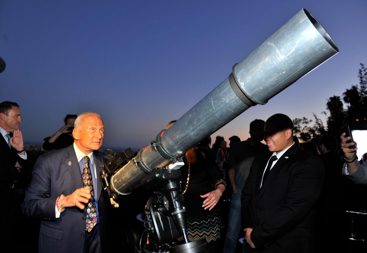 Buzz Aldrin, the second man to walk on the moon, checks out the telescope at a celebration of the 45th anniversary of the Apollo 11 moon landing. The event was hosted by Omega and Vanity Fair.