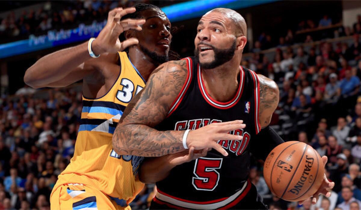 Chicago's Carlos Boozer works his way to the basket against Denver's Kenneth Faried on Nov. 21.