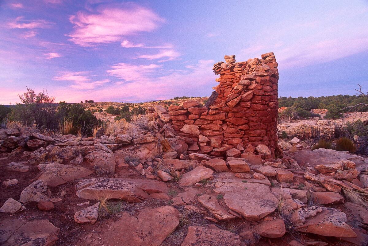 Stacked stones make up ruins in a Southwestern setting.