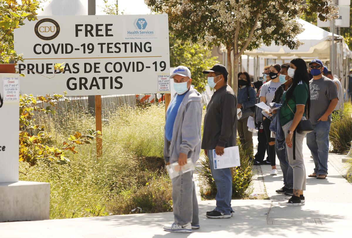 People wait to be tested for COVID-19 outside Charles R. Drew University of Medicine and Science in South L.A. on Wednesday.