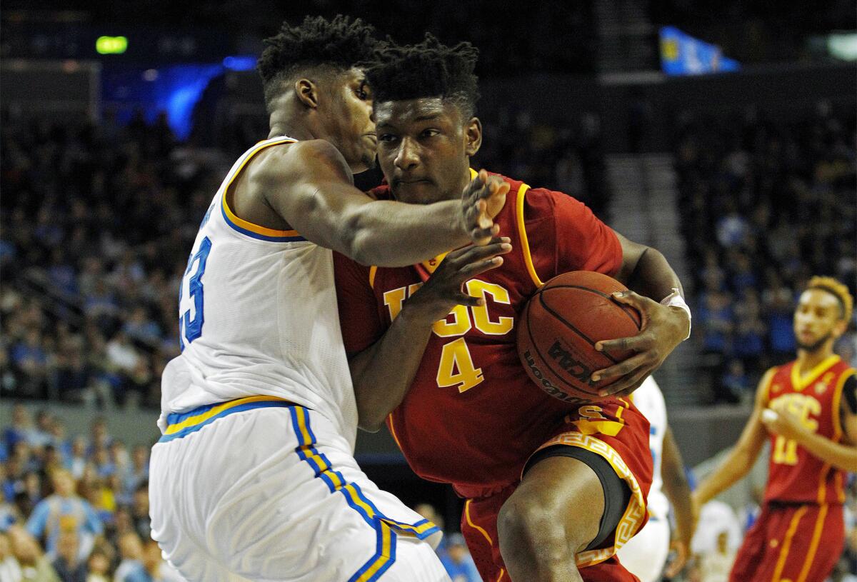 USC forward Chimezie Metu (4) drives to the basket against UCLA forward Tony Parker (23) during the first half Wednesday.
