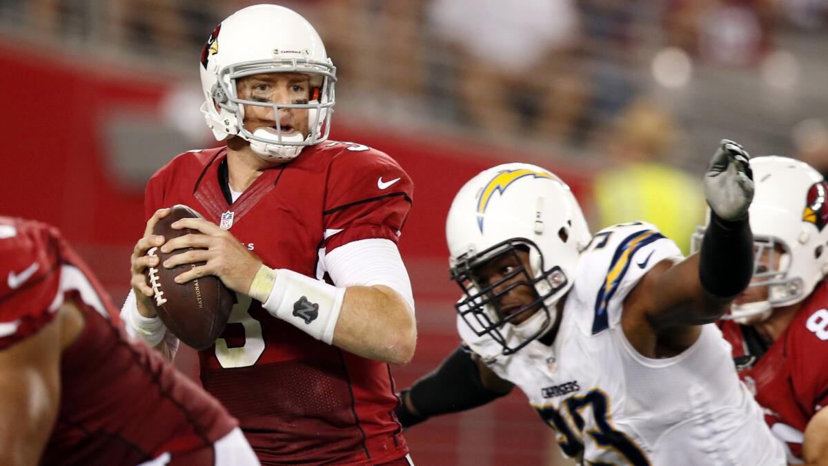 San Diego Chargers linebacker Dwight Freeney, right, closes in on Arizona Cardinals quarterback Carson Palmer during a game on Sept. 8. Freeney is the oldest player on the Chargers.
