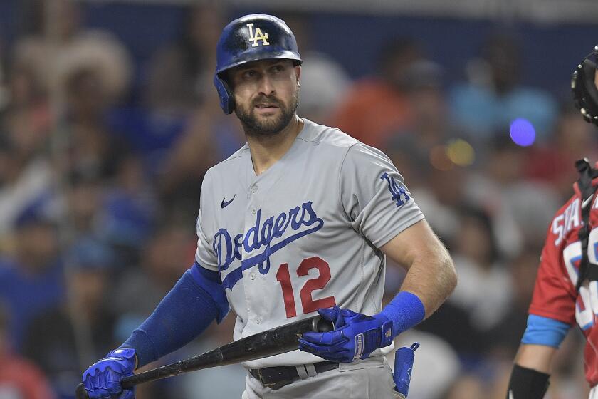 Los Angeles Dodgers Joey Gallo (12) walks past Miami Marlins catcher Jacob Stallings.