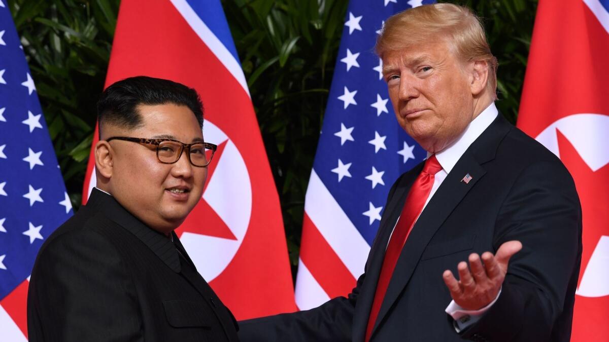 In this photo taken on June 11, 2018, President Trump gestures as he meets with North Korea's leader Kim Jong Un at the Capella Hotel on Sentosa island in Singapore.