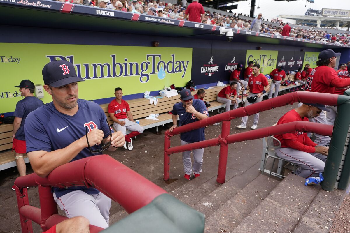 Boston Red Sox hitting coach Peter Fatse (62) watches the warmup in the fourth inning from the dugout during a spring training baseball game against the Atlanta Braves at CoolToday Park, Sunday, April 3, 2022, in North Port, Fla. (AP Photo/Steve Helber)