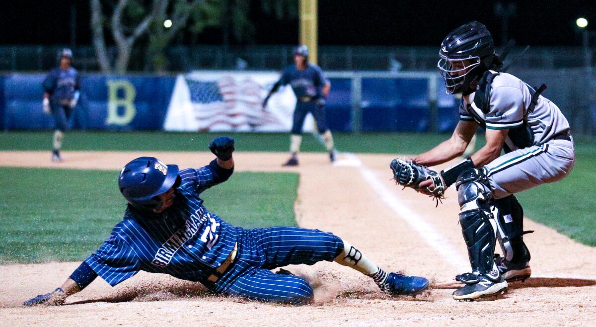 Vince Cervantes of Birmingham slides in safely before Granada Hills catcher Will White receives the throw at home.