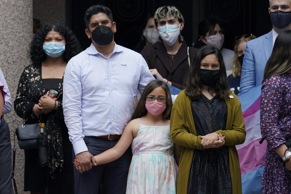 Adults and children wearing masks
