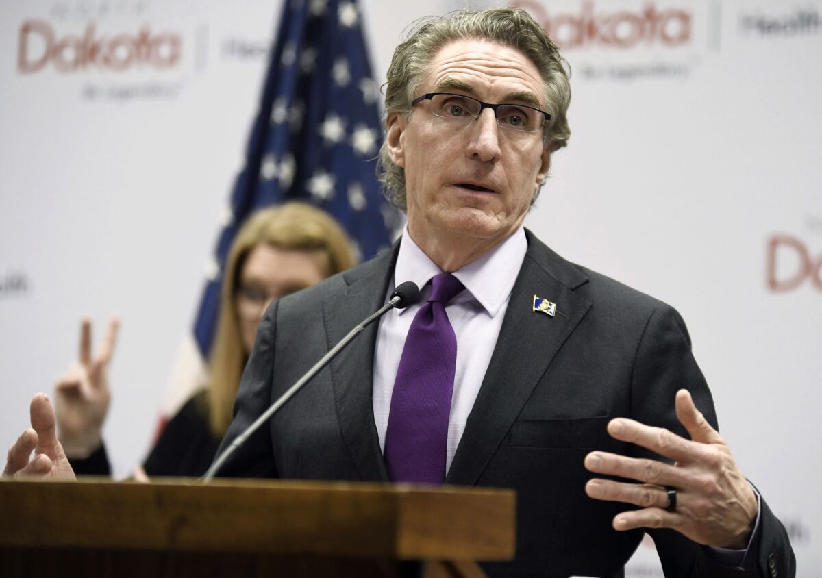 FILE - In this April 10, 2020, file photo, North Dakota Gov. Doug Burgum speaks at the state Capitol in Bismarck, N.D. North Dakota landowners testified for and against a carbon capture company’s use of eminent domain Friday, as Summit Carbon Solutions moves forward in constructing a massive underground system of carbon dioxide pipelines – spanning 2,000 miles across several states, under hundreds of people’s homes and farms in the Midwest. Republican Gov. Doug Burgum lauded North Dakota’s efforts to store carbon dioxide in January 2023. (Mike McCleary/The Bismarck Tribune via AP, File)