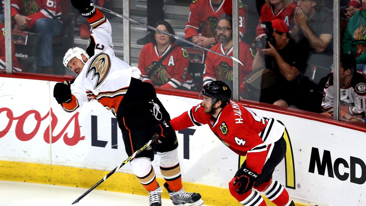 Ducks center Ryan Getzlaf is sent reeling by a check from Blackhawks defenseman Niklas Hjalmarsson during Game 6 on Wednesday night in Chicago.