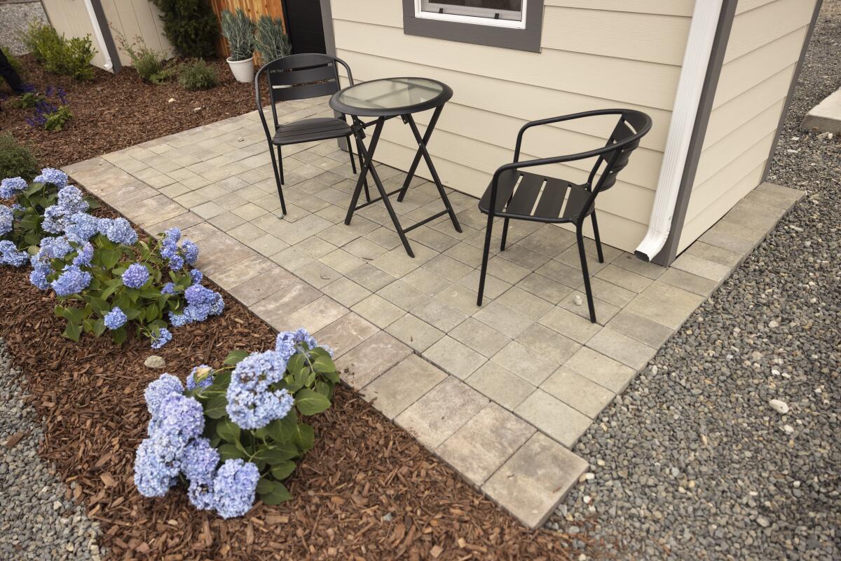 Next to the pavement and a cleanup area is a living structure.