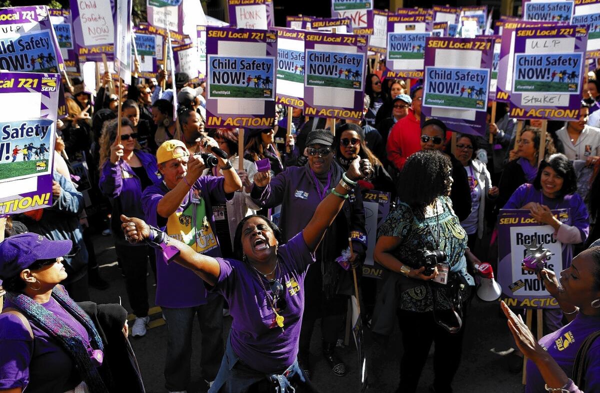 Shannon McClenney, center, demonstrates on the second day of a rally by L.A. County social workers outside the Department of Children and Family Services. The department's director, Philip Browning, made a surprise appearance to ask protesters to return to work, prompting boos from the crowd.