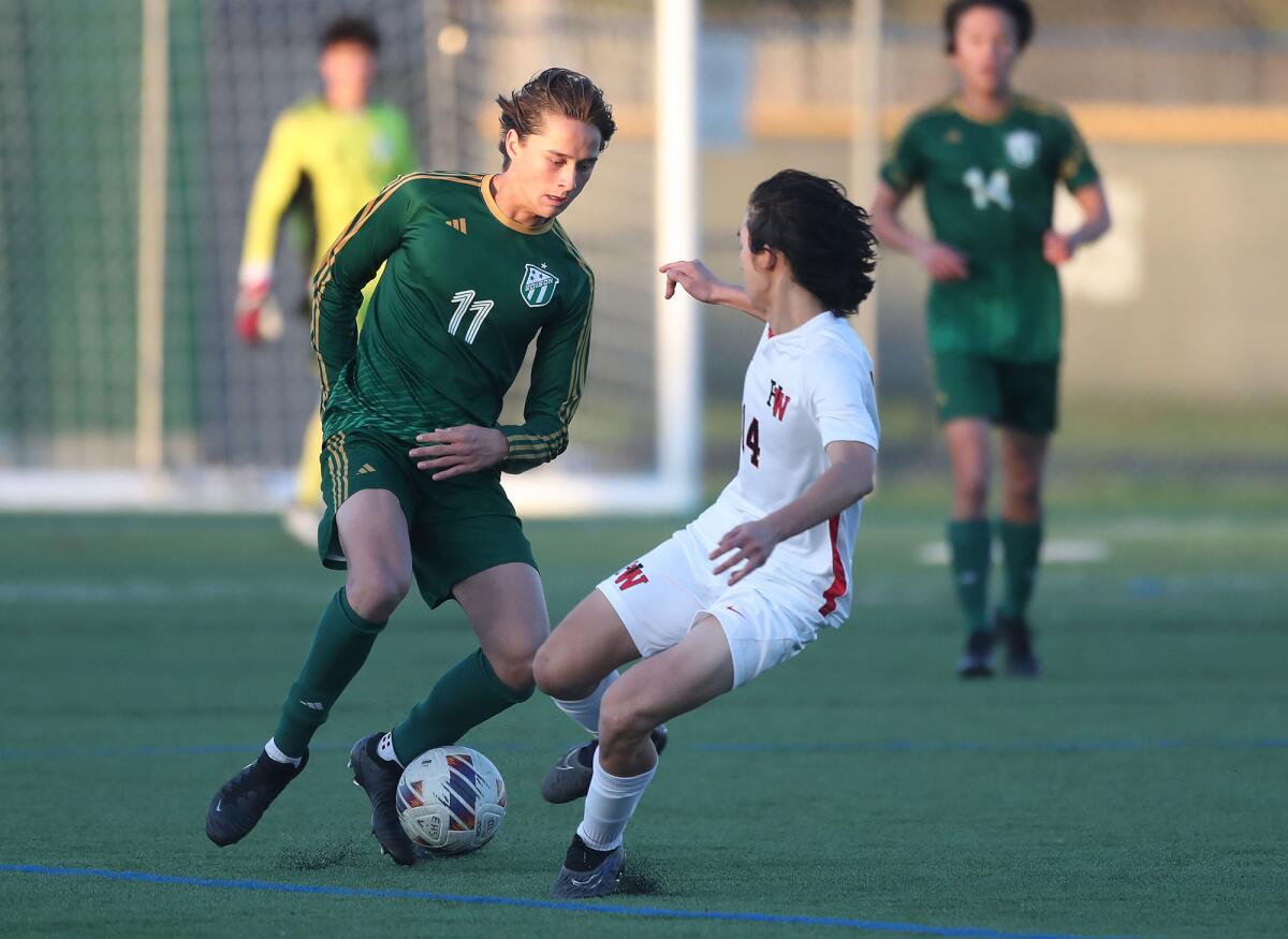 Edison's Micah Novak (11) skillfully dribbles past Harvard-Westlake's Kevin Chen (14) on Friday.