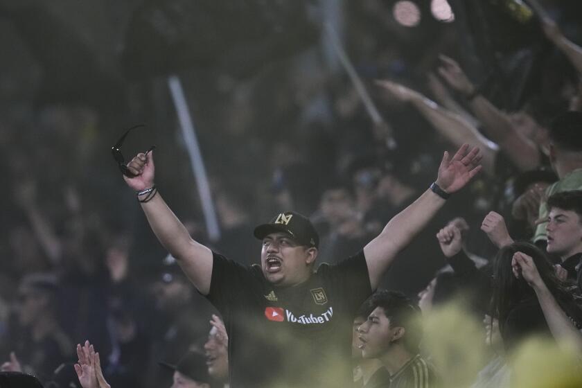 Los Angeles FC fans cheer after forward Denis Bouanga scored during the first half of an MLS soccer match against the Vancouver Whitecaps in Los Angeles, Saturday, May 11, 2024. (AP Photo/Ashley Landis)