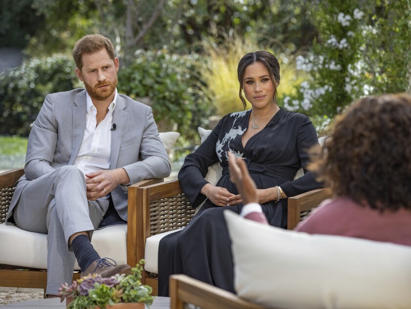 This image provided by Harpo Productions shows Prince Harry, left, and Meghan, Duchess of Sussex, in conversation with Oprah Winfrey. "Oprah with Meghan and Harry: A CBS Primetime Special" airs March 7, 2021. Britain’s royal family and television have a complicated relationship. The medium has helped define the modern monarchy: The 1953 coronation of Queen Elizabeth II was Britain’s first mass TV spectacle. Since then, rare interviews have given a glimpse behind palace curtains at the all-too-human family within. (Joe Pugliese/Harpo Productions via AP, File)