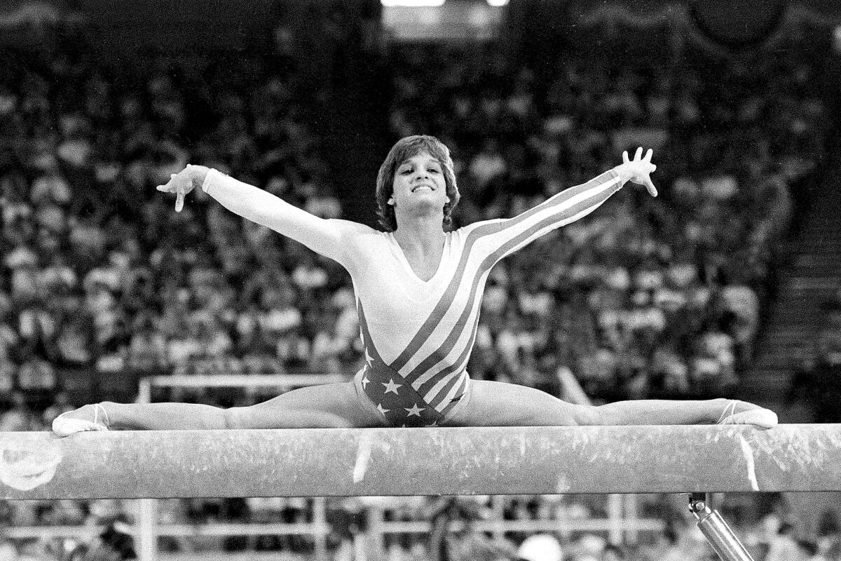 FILE - In this Aug. 3, 1984, file photo, Mary Lou Retton, of the United States, performs on the balance beam during the women's gymnastics individual all-around finals at the Summer Olympic Games in Los Angeles. (AP Photo/Suzanne Vlamis, File)