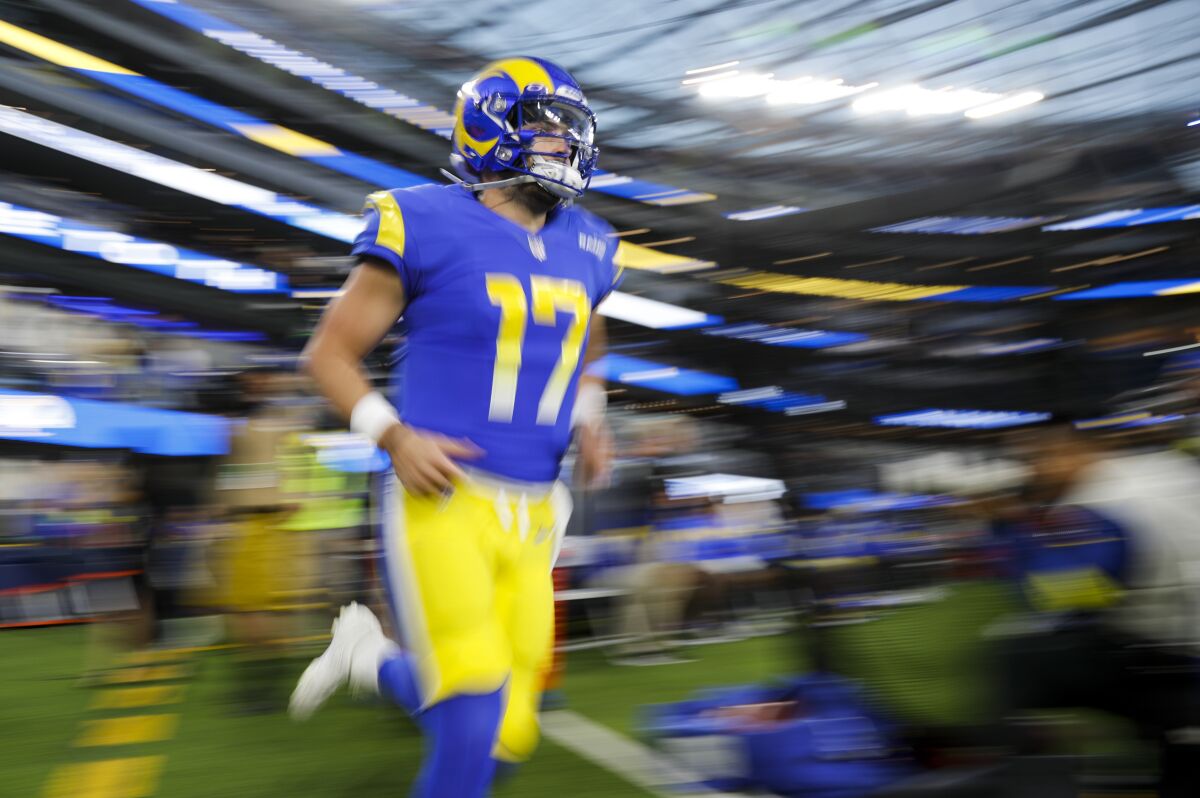 Rams quarterback Baker Mayfield runs onto the field for pregame warmups Thursday.