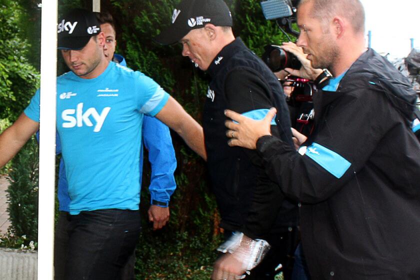 Reigning Tour de France champion Chris Froome (center) arrives at his hotel in Marcq-en-Barul, France, after withdrawing from the race following two crashes during the fifth stage on Wednesday.