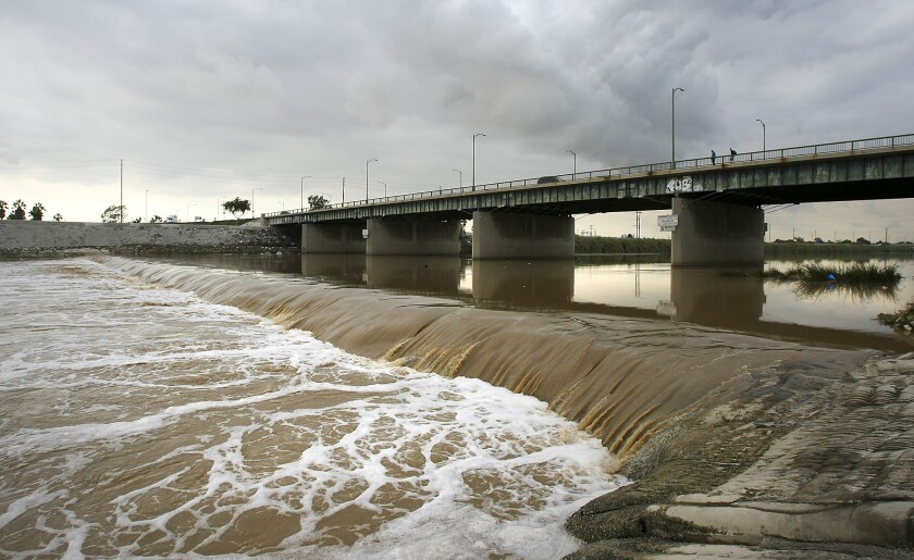 The Los Angeles River flows under the Anaheim Street bridge on its way to Long Beach Harbor.