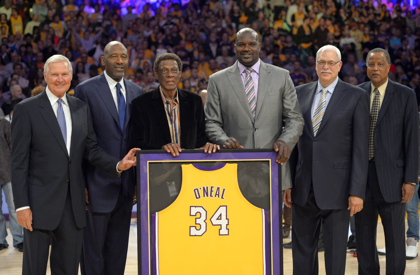 Former Los Angeles Lakers, from left, Jerry West, James Worthy, Elgin Baylor, Shaquille O'Neal, Jamaal Wilkes and former coach Phil Jackson pose as they retired his O'Neal's jersey during the half of the Lakers' NBA basketball game against the Dallas Mavericks, Tuesday, April 2, 2013, in Los Angeles.