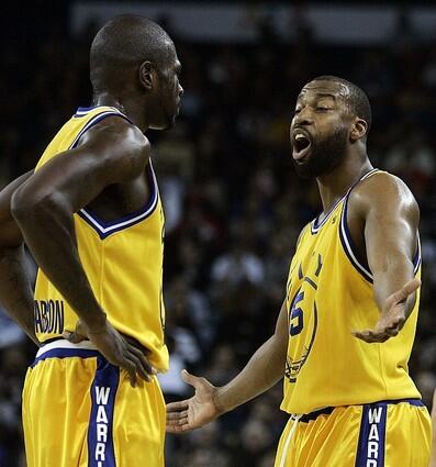 Golden State Warriors' Baron Davis, right, reacts to a foul call with as he stands next to Jason Richardson.