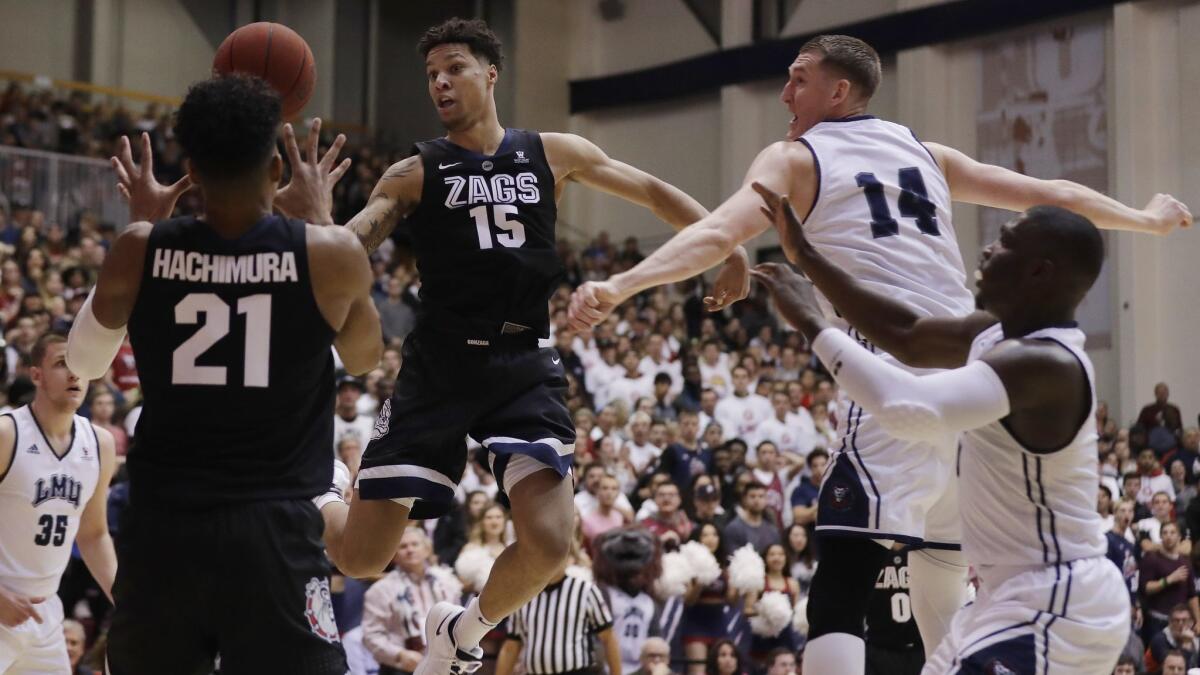 Gonzaga forward Brandon Clarke (15) passes to teammate Rui Hachimura (21) during the first half against Loyola Marymount on Thursday.