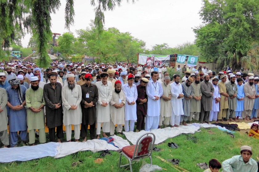 Pakistani civilians who were displaced by the anti-insurgent operation in North Waziristan offer Eid al-Fitr prayers at the end of the fasting month of Ramadan in Bannu on July 28.