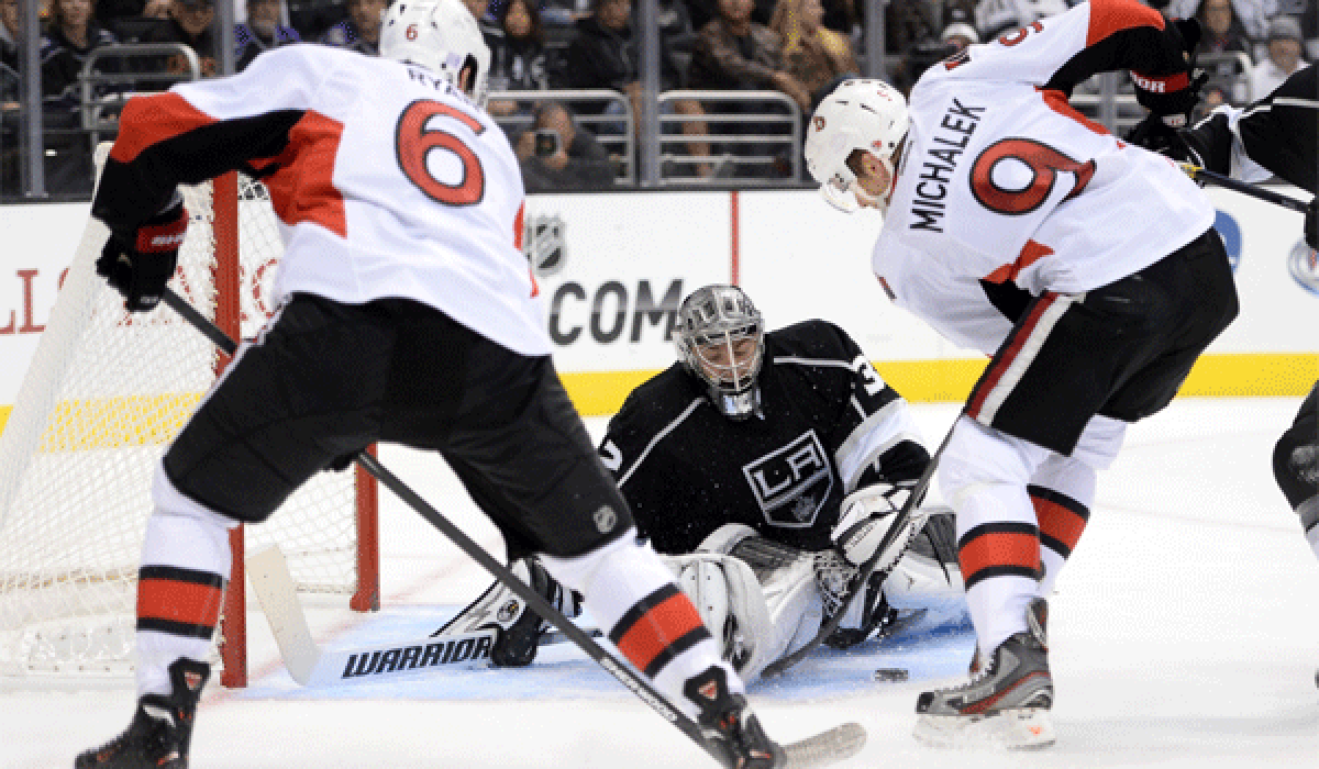 Jonathan Quick stops a shot from Ottawa's Milan Michalek, right, as Bobby Ryan looks for a rebound during an Oct. 9 overtime victory for the Kings.