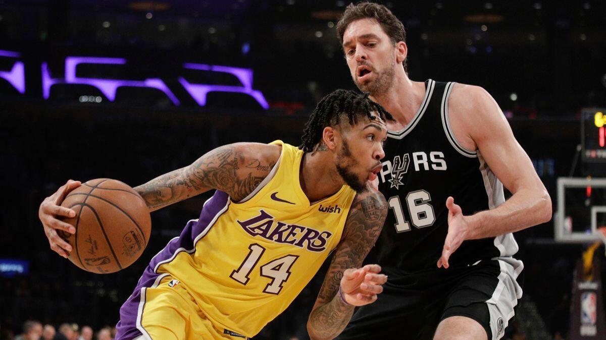 Brandon Ingram of the Lakers drives past Pau Gasol of the Spurs during the first half on Thursday.