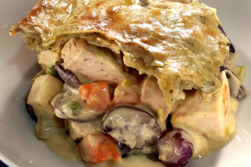 Pot pie is filled with turkey, pearl onions, mushrooms, potatoes and peas.