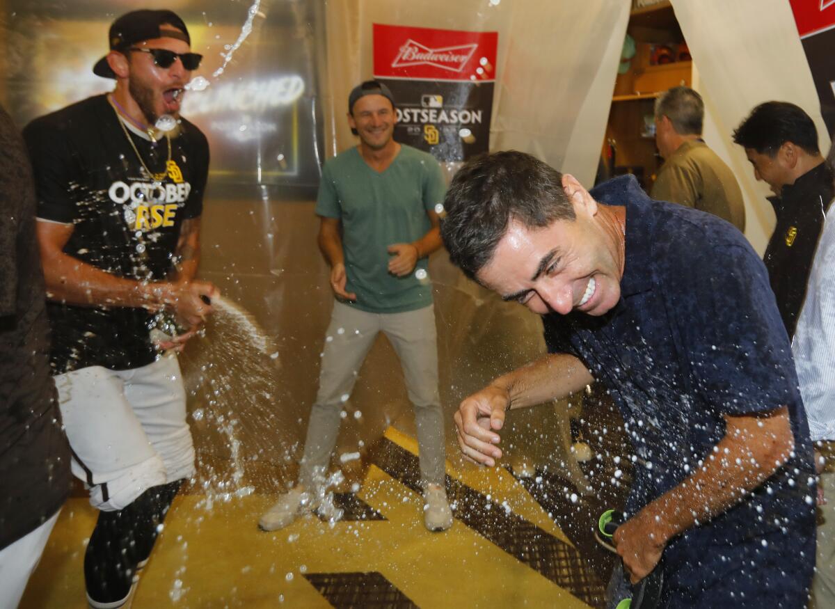 Pitcher Joe Musgrove drenches A.J. Preller in the clubhouse after Padres clinched a playoff spot 