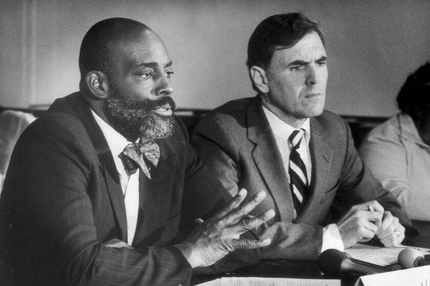 Boston mayoral candidates Mel King, left, and Raymond Flynn participate in a debate, Nov. 7, 1983, at the Old South Church in Boston. King, a civil rights activist whose campaign for mayor helped the city begin to repair some of the racial divisions sparked during the city's school busing crisis, has died. He was 94. (John Blanding/The Boston Globe via AP, File)