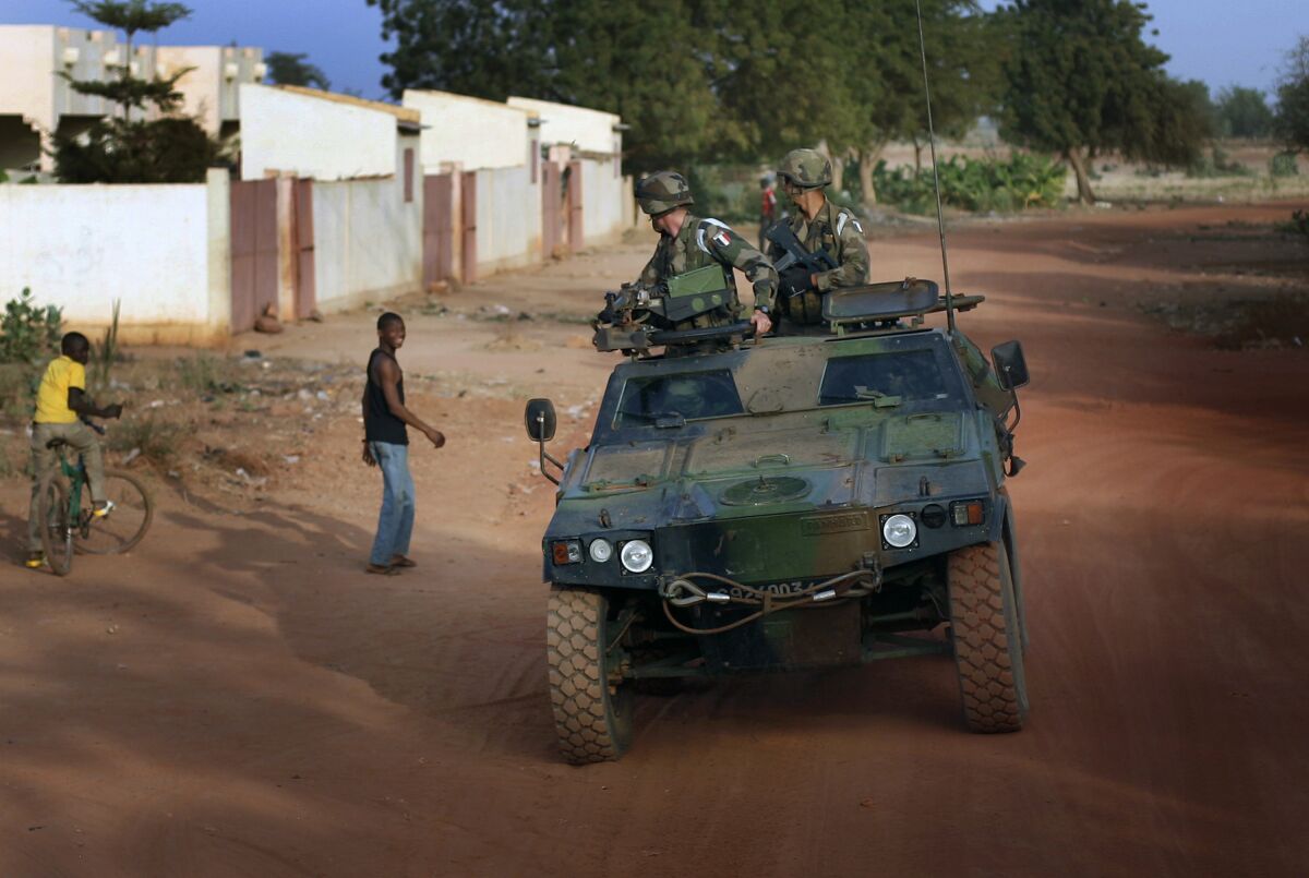 FILE - French soldiers return from patrol in Sevare, some 620 kms (400 miles) north of Mali's capital Bamako, Thursday, Jan. 24, 2013. French President Emmanuel Macron announced at a press conference Thursday Feb. 17, 2022 that he is withdrawing French troops from Mali. France intends to maintain its military operations to fight Islamic extremism in other countries in Africa's broader Sahel region. (AP Photo/Jerome Delay, File)
