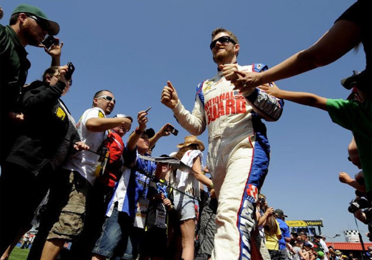 Dale Earnhardt Jr. greets fans before the start of the Auto Club 400 in Fontana.