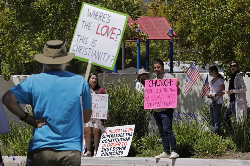 NEWBURY PARK, CA - AUGUST 09: Supporters and protestors gather at Godspeak Calvary Chapel in Newbury Park for Pastor Rob McCoy who defied a judge's order and held indoor services on Sunday, Aug. 9, 2020 in Newbury Park, CA. (Myung J. Chun / Los Angeles Times)