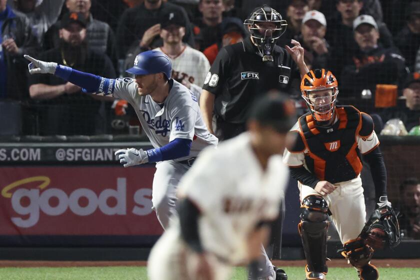 San Francisco, CA - October 14: Los Angeles Dodgers' Cody Bellinger gestures after hitting the go-ahead RBI single.