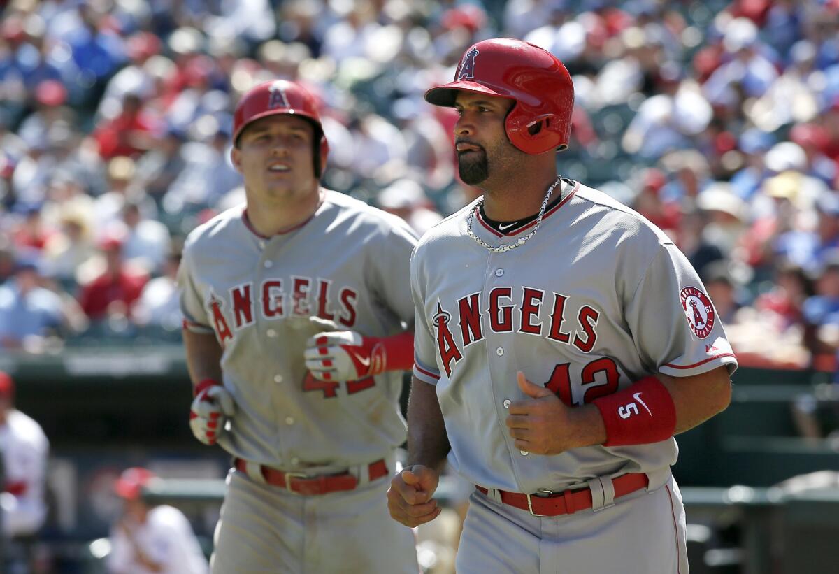 The Angels' offense, led by Mike Trout, left, exploded for 10 runs on 13 hits in the series finale against the Rangers.