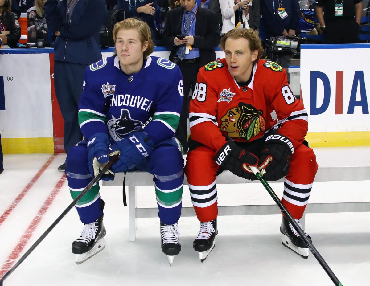 Brock Boeser, left, of Vancouver sits with Patrick Kane of Chicago during the NHL All-Star Skills Competition.