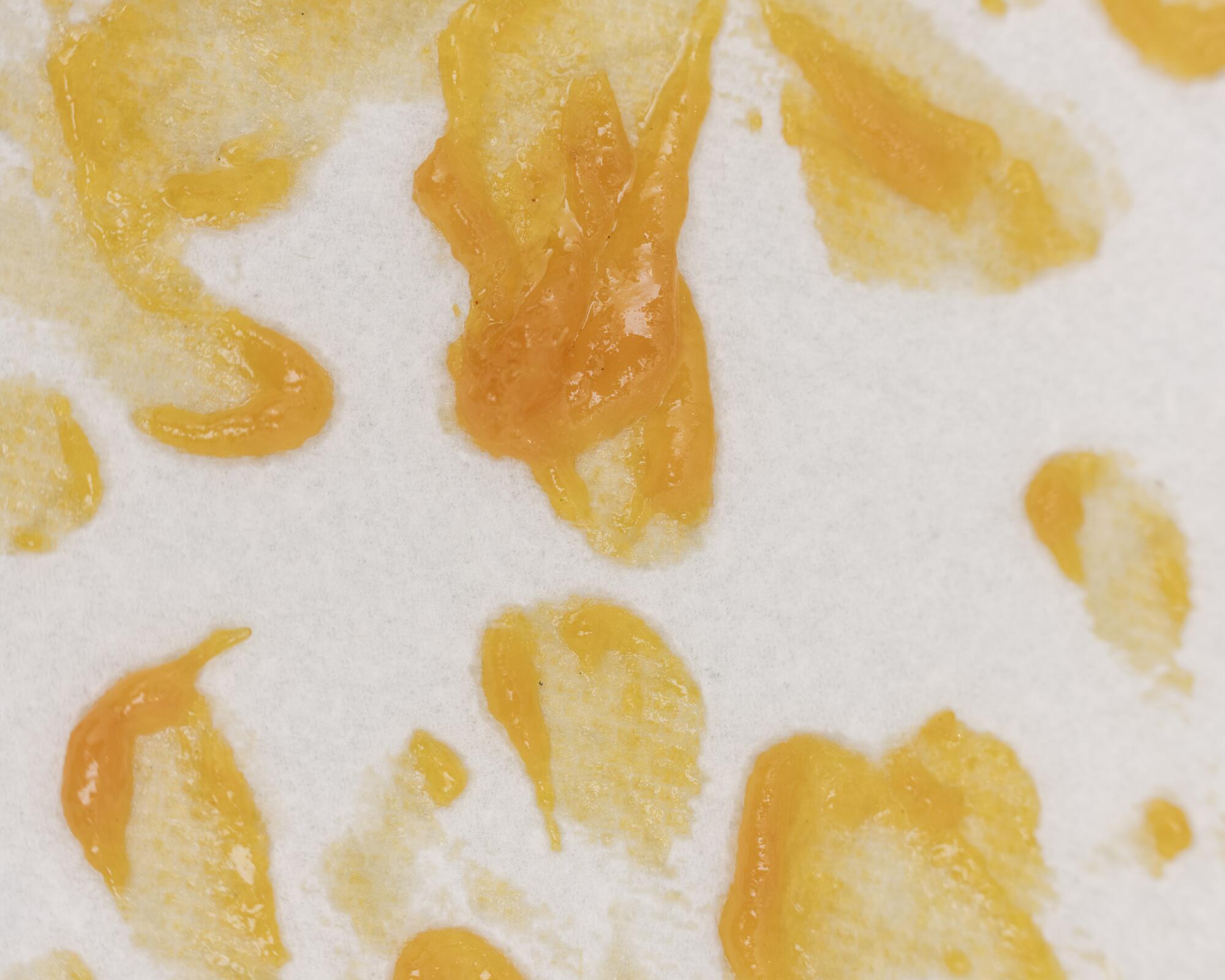Orange smears are the residue from removing imperfections from sun-dried apricots. 