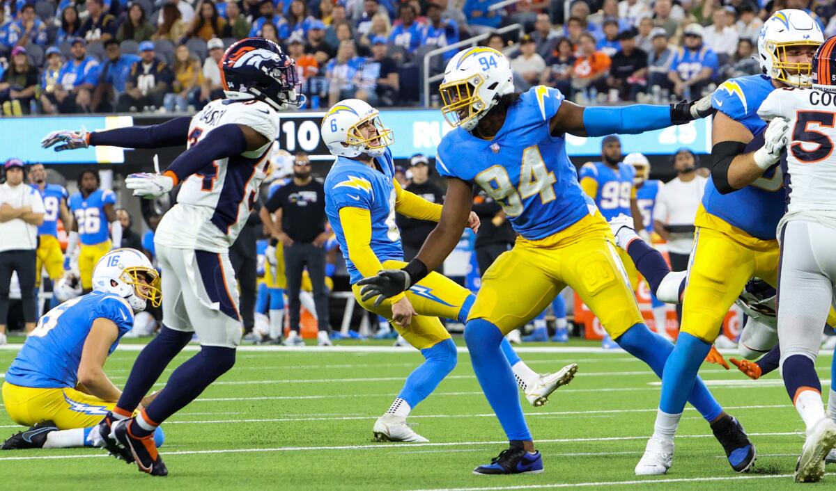 Chargers kicker Dustin Hopkins grimaces in pain as he kicks a 35-yard field goal to tie the game.