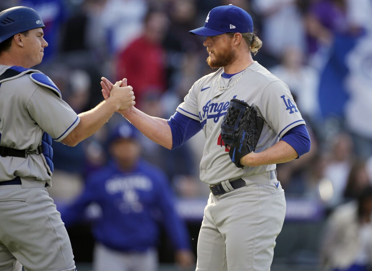 New Dodgers closer Craig Kimbrel, right, is congratulated by catcher Will Smith after the final out in the season opener.