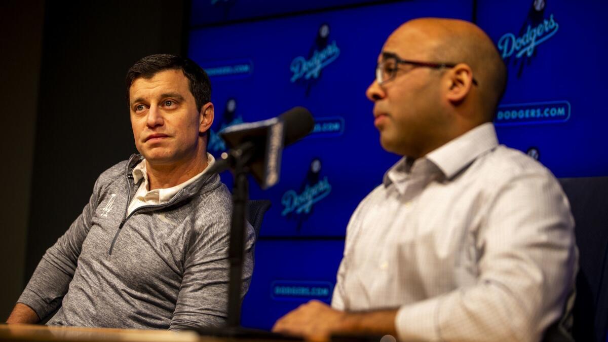 Andrew Friedman (right) and Farhan Zaidi (left) speak at a press conference at Dodger Stadium.