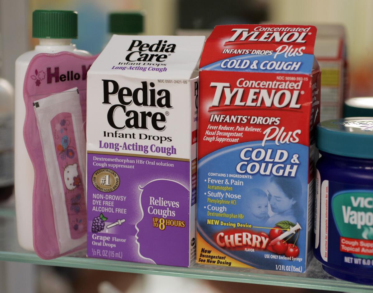 Boxes of Pedia Care and Tylenol  in a medicine cabinet