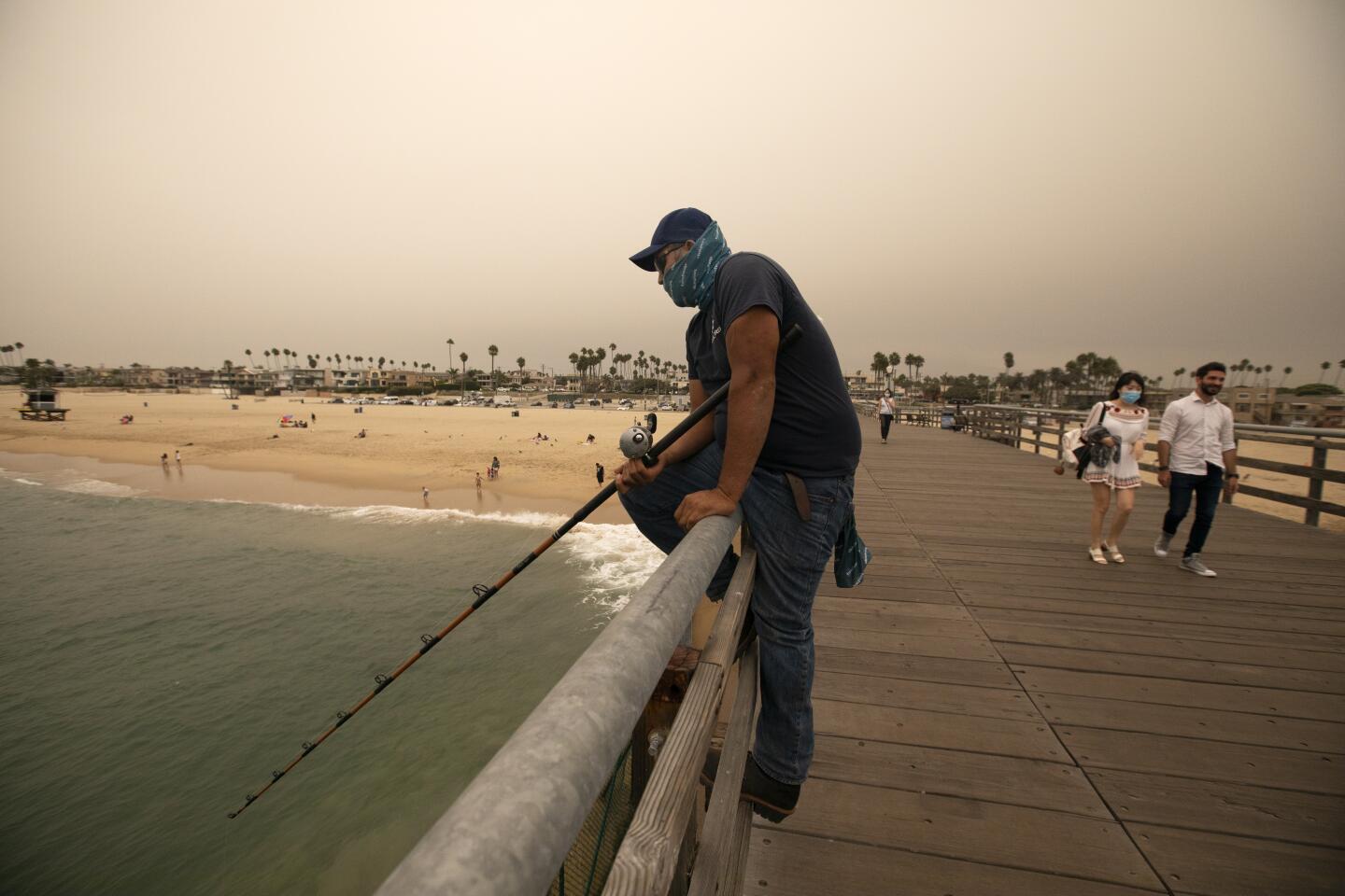 Fabian Ortez of Riverside enjoys fishing off the pier in Seal Beach.