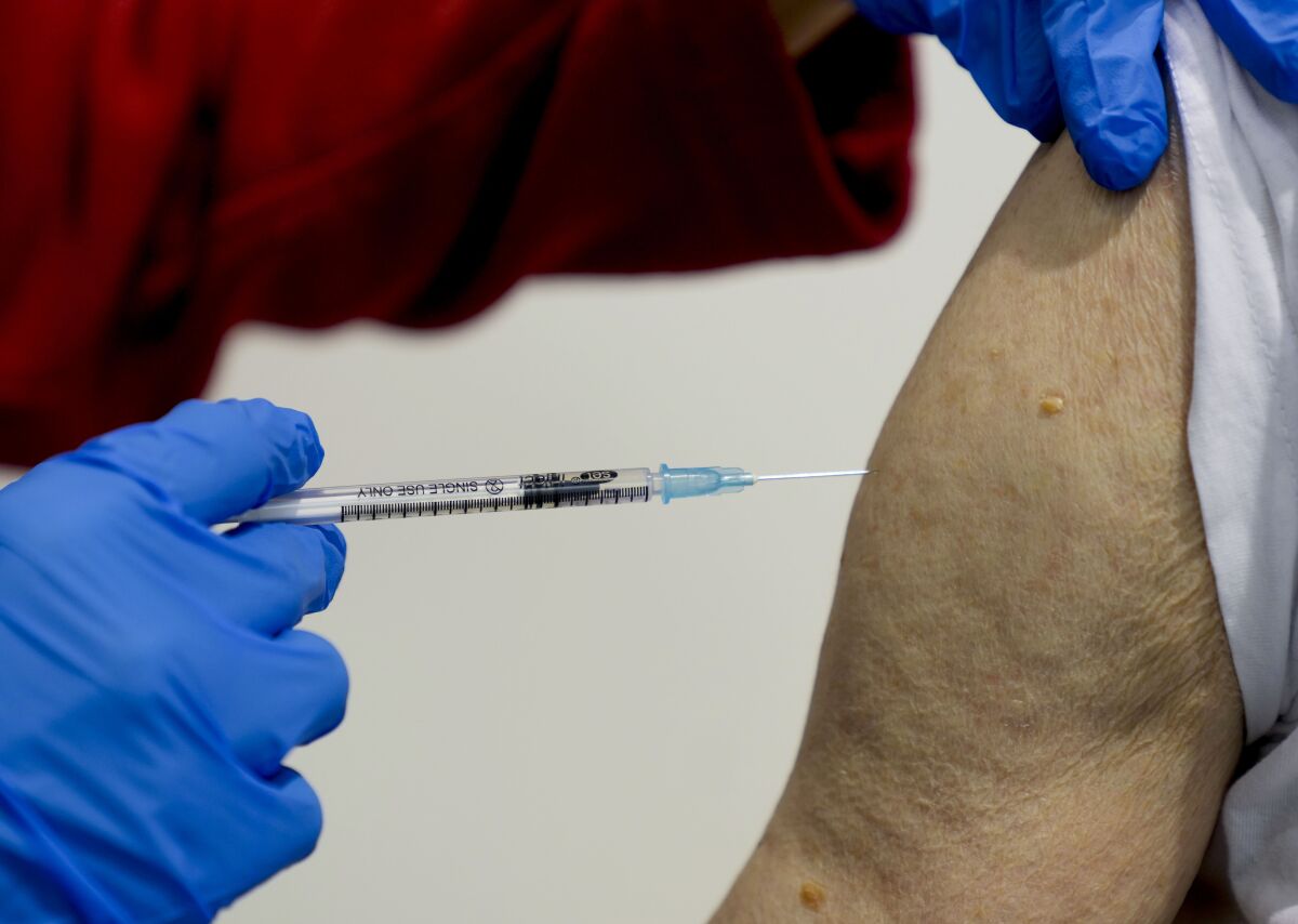 File-File photo shows a 87-year-old man getting his booster shot at the vaccination center in Frankfurt, Germany, Thursday, Nov. 11, 2021. A-60-year-old man allegedly had himself vaccinated against Covid-19 dozens of times in Germany in order to sell forged vaccination cards with real vaccine batch numbers. (AP Photo/Michael Probst,file)