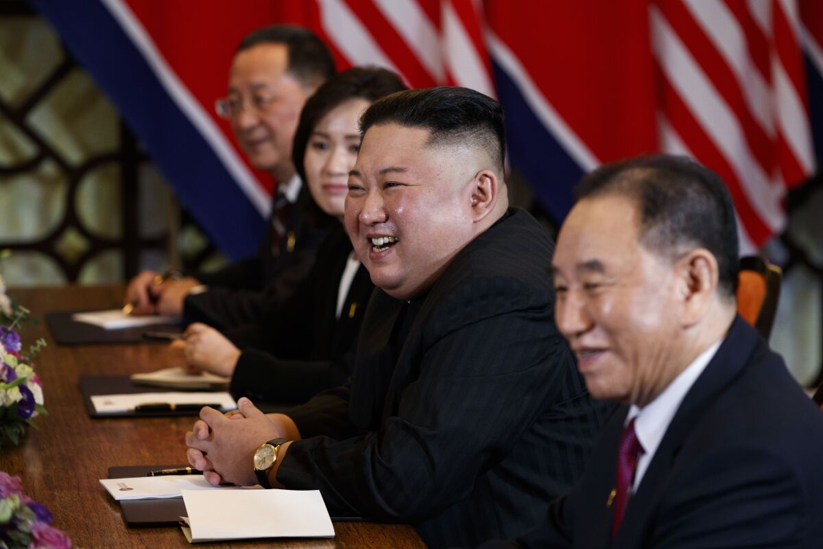 FILE - In this Feb. 28, 2019, file photo, North Korean leader Kim Jong Un smiles during a meeting with President Donald Trump, Thursday, Feb. 28, 2019, in Hanoi. at right is Kim Yong Chol, a North Korean senior ruling party official and former intelligence chief. North Korea on Wednesday, Aug. 11, 2021, repeated a threat to respond to U.S.-South Korean military exercises it claims are an invasion rehearsal, while the United States insisted the drills were “purely defensive in nature” to maintain the South’s security. (AP Photo/ Evan Vucci, File)