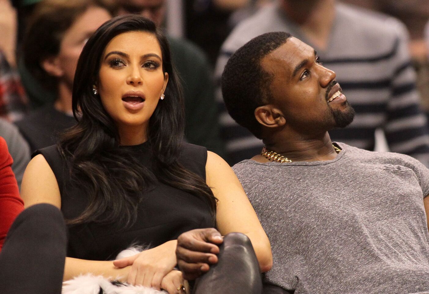 Kim Kardashian and Kanye West attend the NBA game between the Clippers and the Denver Nuggets at Staples Center on Dec. 25, 2012.