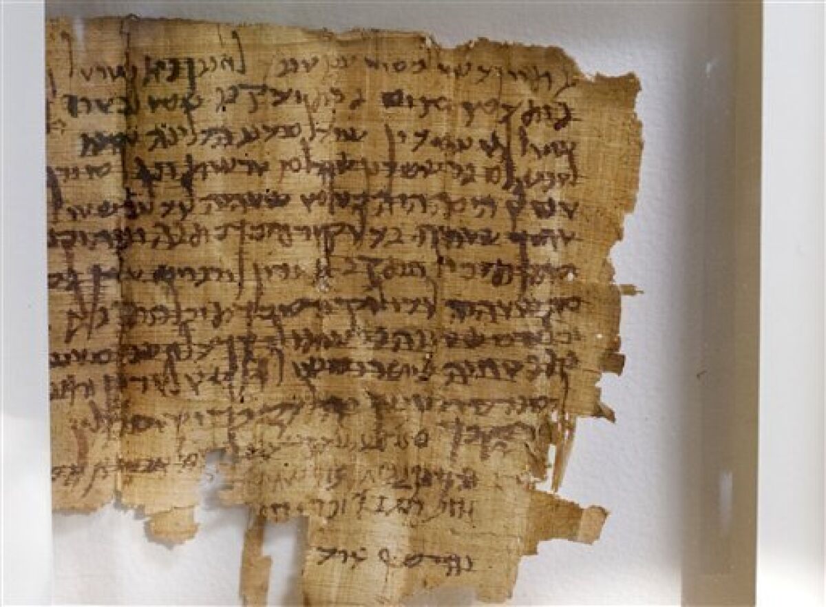 An ancient Hebrew document dated to the 2nd century A.D. is seen a day after it was seized by Israeli police officers, in Jerusalem, Wednesday, May 6, 2009. Undercover Israeli officers foiled an attempt by two Palestinian men to sell an ancient, valuable papyrus document on the black market, police said Wednesday. The document, six inches by six inches (15 centimeters by 15 centimeters), contains 15 lines of Hebrew characters of a type also used in the Dead Sea Scrolls, ancient holy books and apocalyptic treatises thought to have been collected by an ascetic Jewish sect two millennia ago, but is a a legal text apparently unrelated to the more famous scrolls. (AP Photo/Sebastian Scheiner)