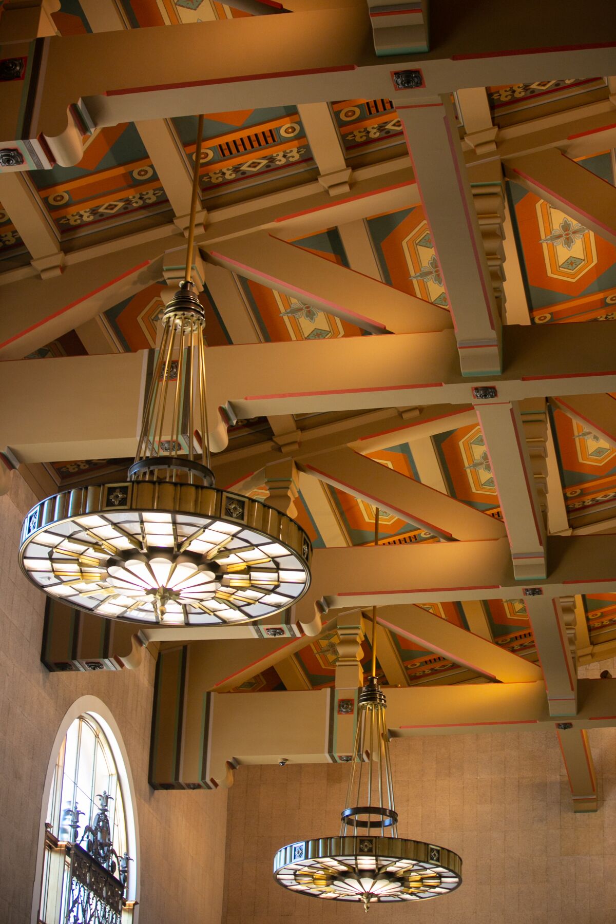 Lively ceiling panels and stained-glass chandeliers in the ticket concourse at Union Station.
