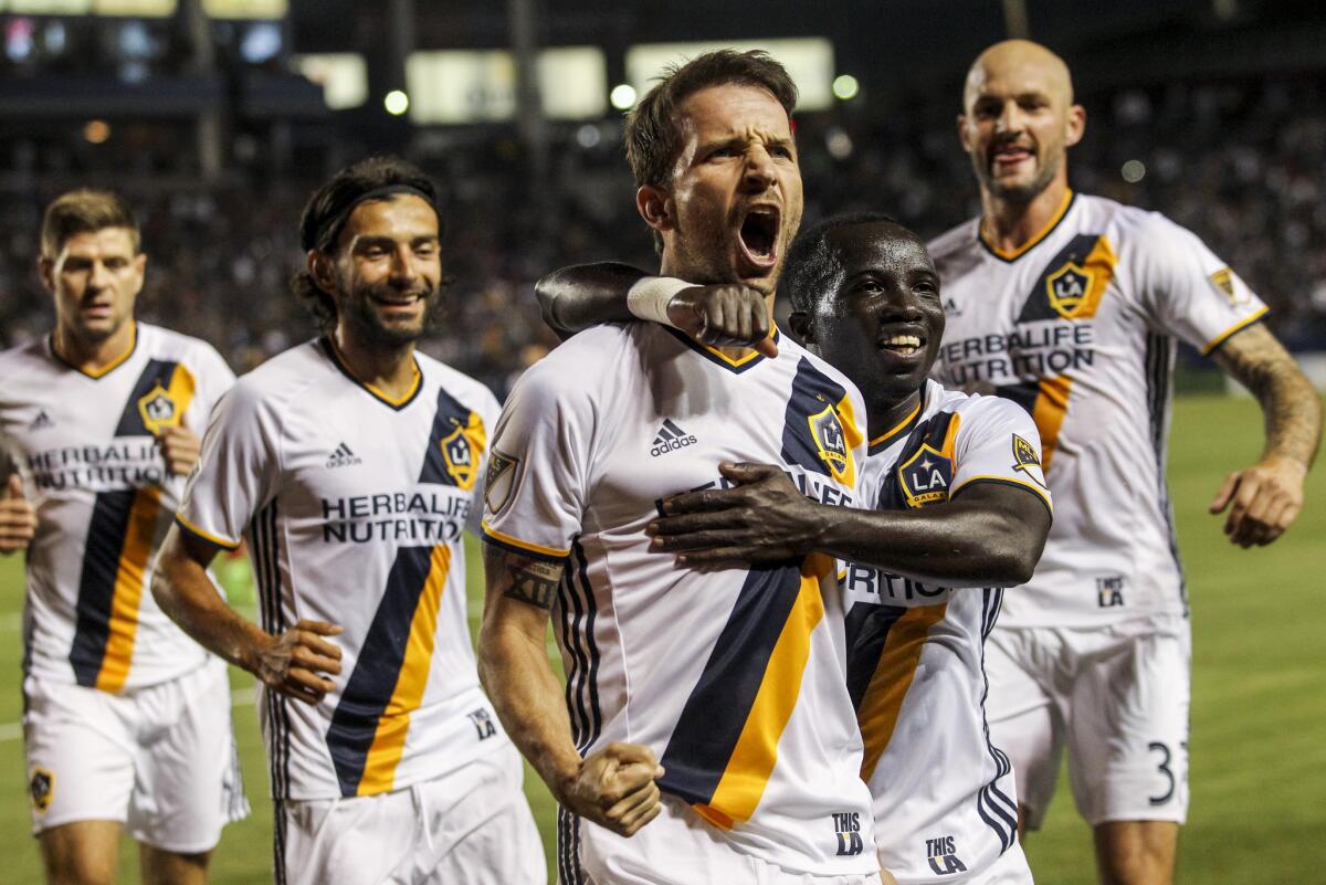 Galaxy midfielder Mike Magee, center, celebrate his goal against Real Salt Lake with his teammates during the first half of a game on April 23.